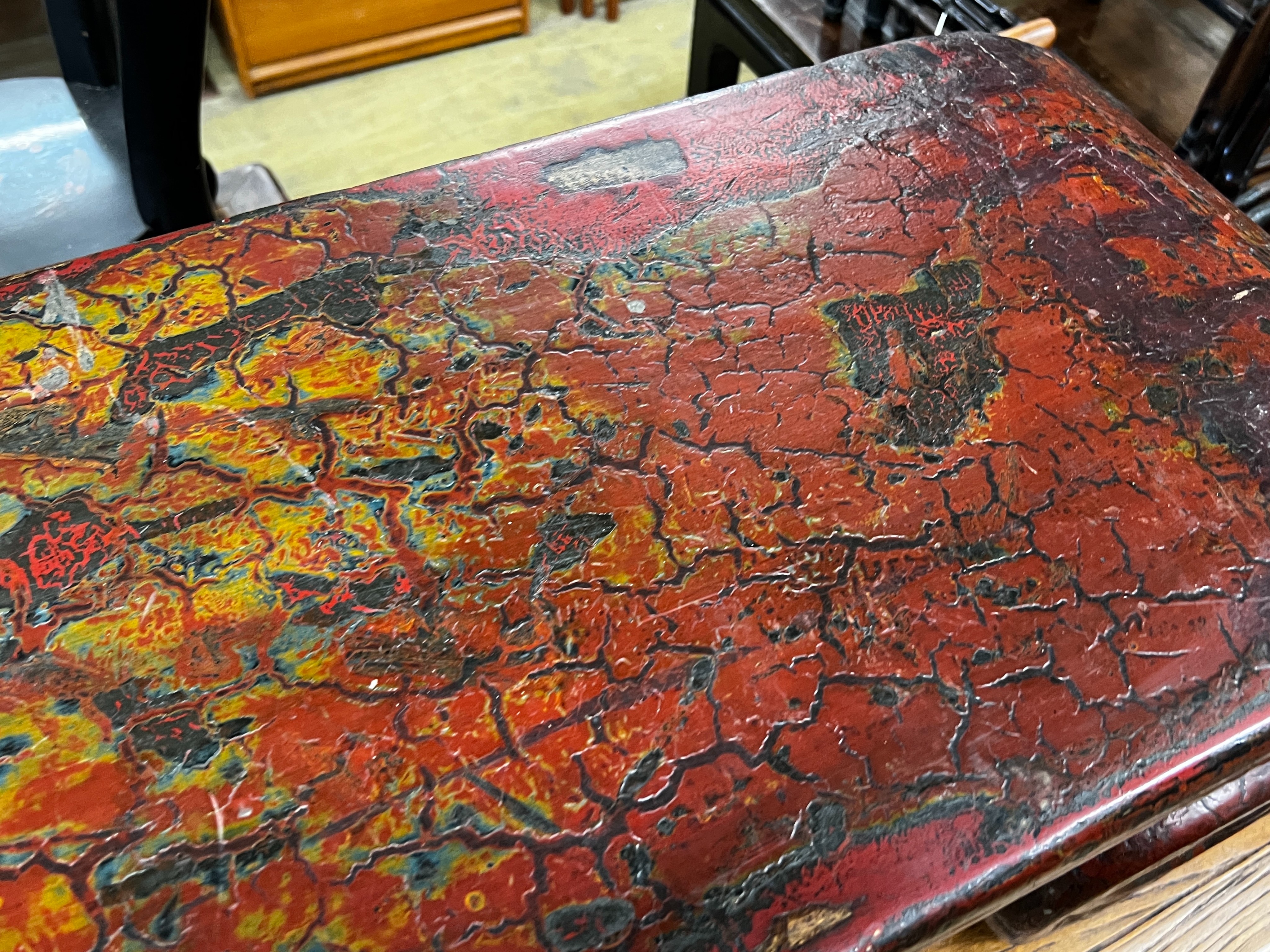 A Chinese lacquer scroll end low table, width 146cm, depth 35cm, height 33cm